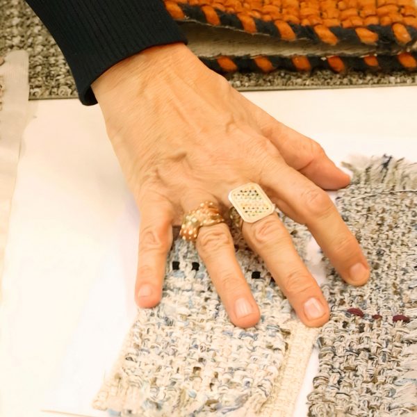 Photo of a hand touching textiles