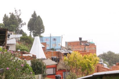 Water harvester in distance with buildings