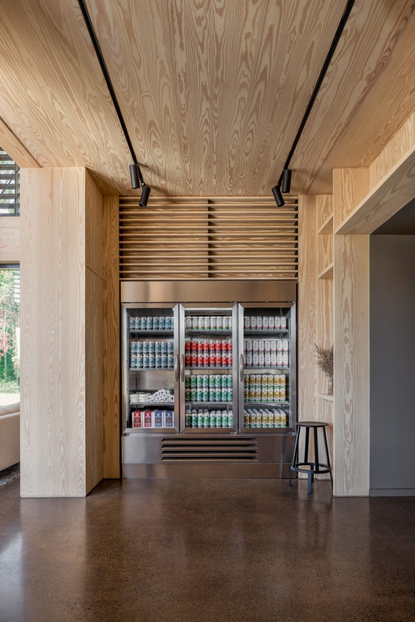 Timber-clad room with polished concrete flor and fridges filled with beer