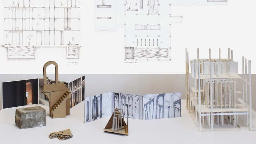 A photograph of a display that includes a model and print-outs with technical drawings