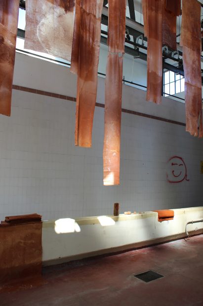 Hanging textiles and old bricks at Alcova