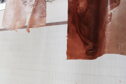 Hanging reddish hued bio textiles by Natural Material Studio