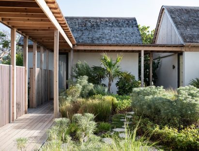 Central courtyard with lush vegetation and gabled roofs on pavilions