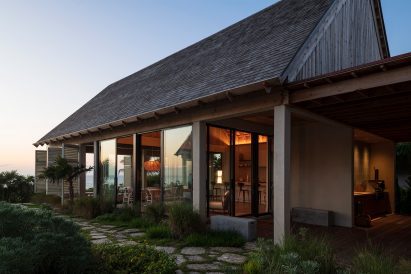 Gabled roof and sliding floor-to-ceiling glazing and shutters on Bahamas house by Brillhart and Garth Sawyer
