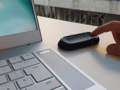 Small device on desk next to laptop