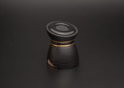 Small black device on dark grey background