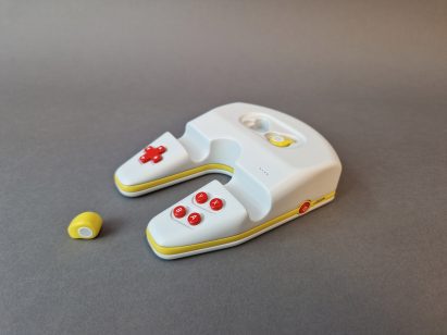 Games console controller-like device on grey backdrop