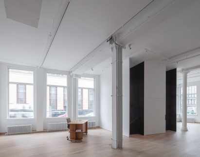 The main gallery space is surrounded by windows and features historic details