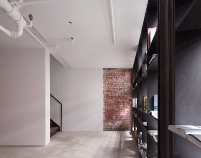 A staircase leads down to more space at cellar level