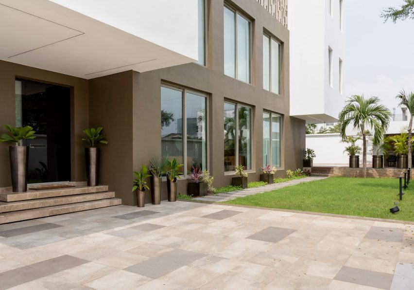 Exterior entrance of the Lantern House by CmDesign Atelier with stone paving and steps leading to the frot door
