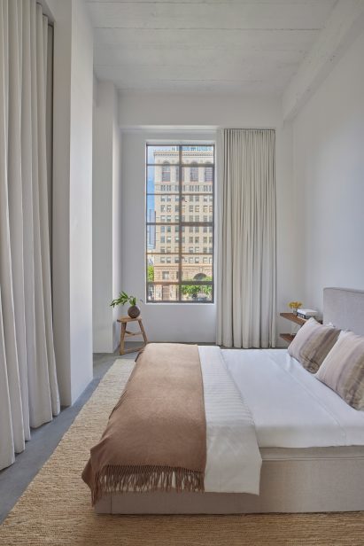 Bedroom with tall ceiling and drapery