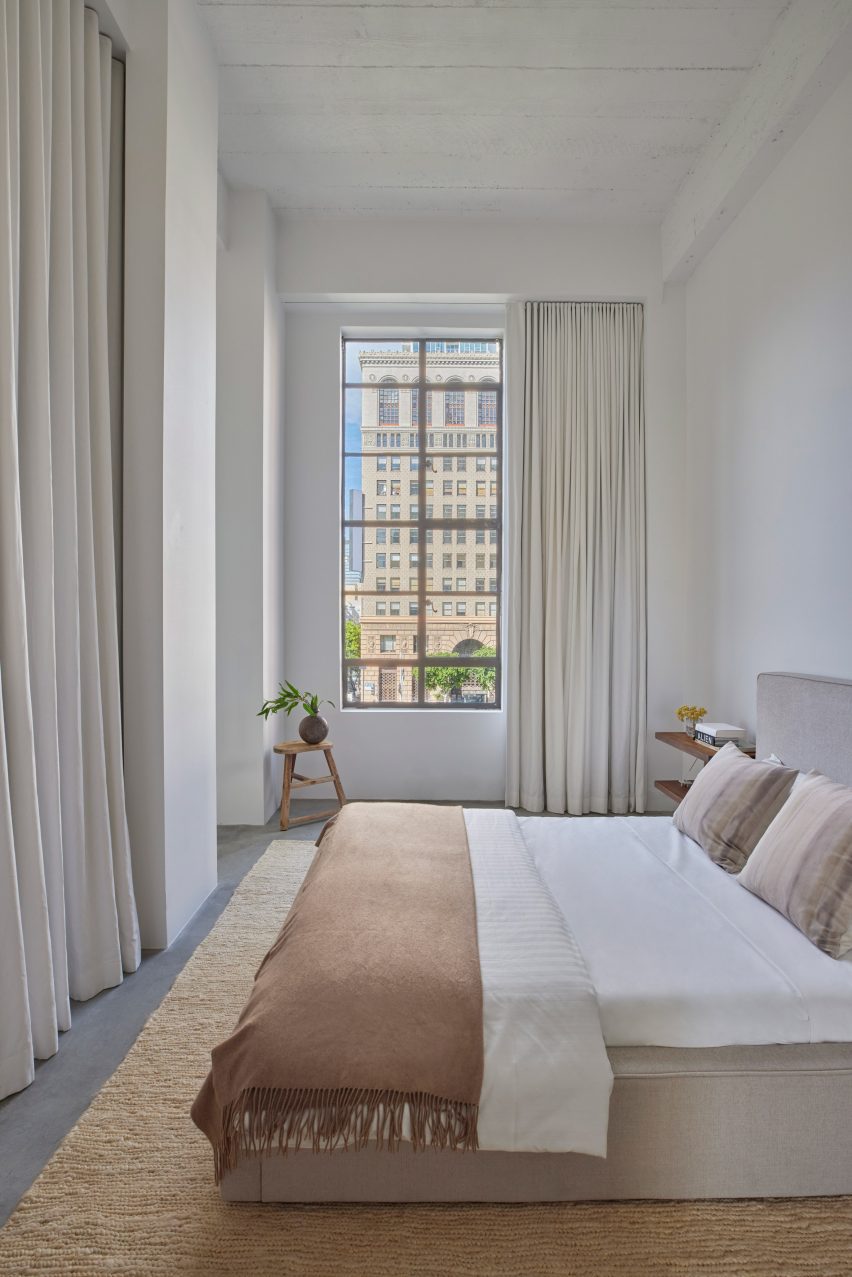 Bedroom with tall ceiling and drapery