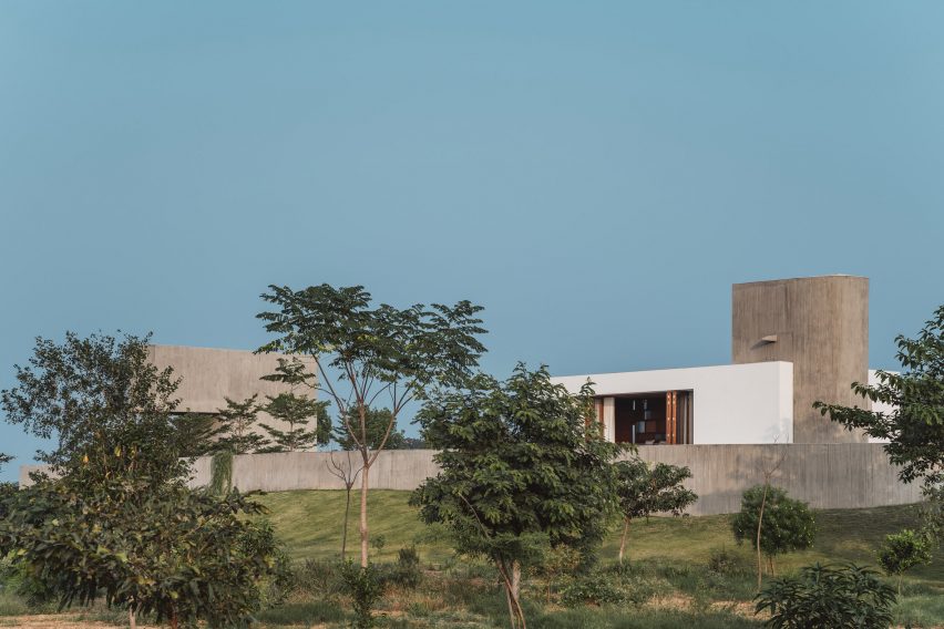Exterior of a home on a grass mound with board-formed concrete walls