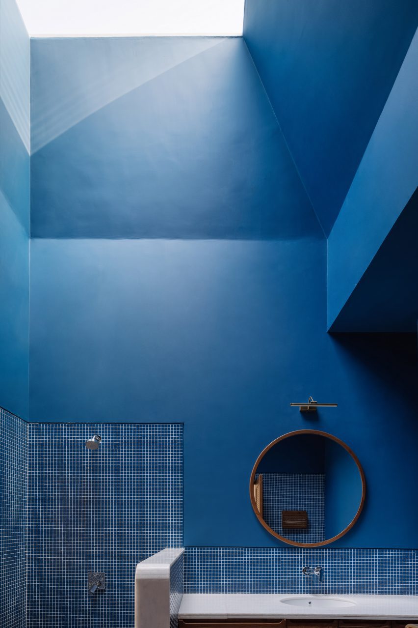 Monochrome blue bathroom with a skylight