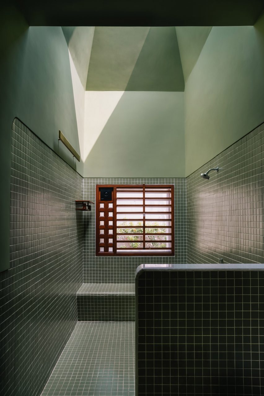 Monochrome green bathroom with a skylight