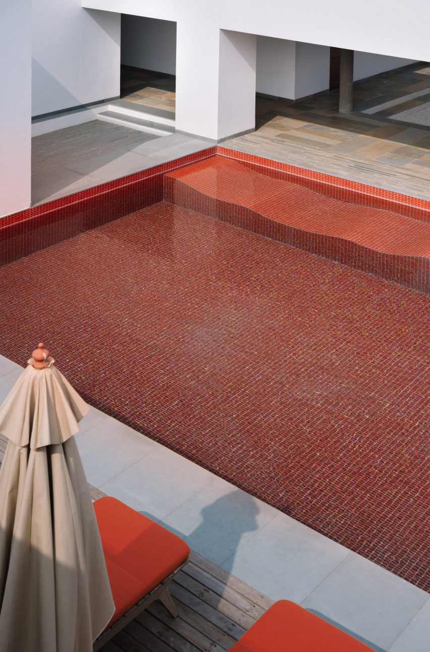 Outdoor swimming pool with red tiles