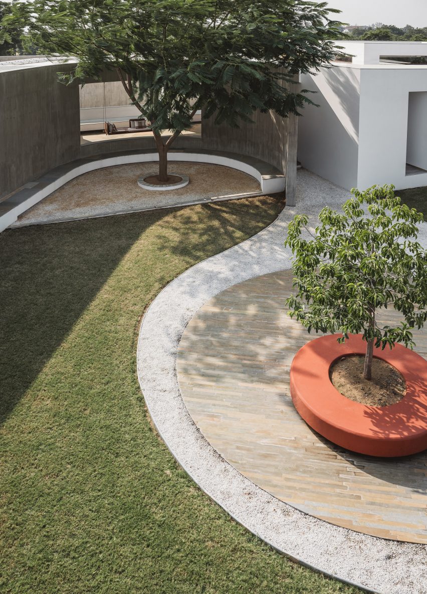 Grass courtyard with curved paving and trees