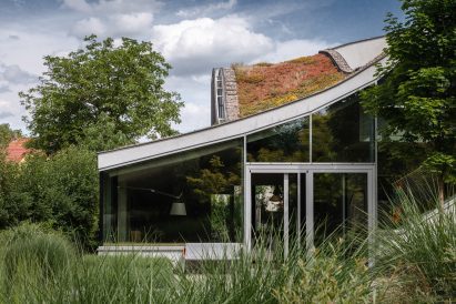 Home with glazed facade and green roof