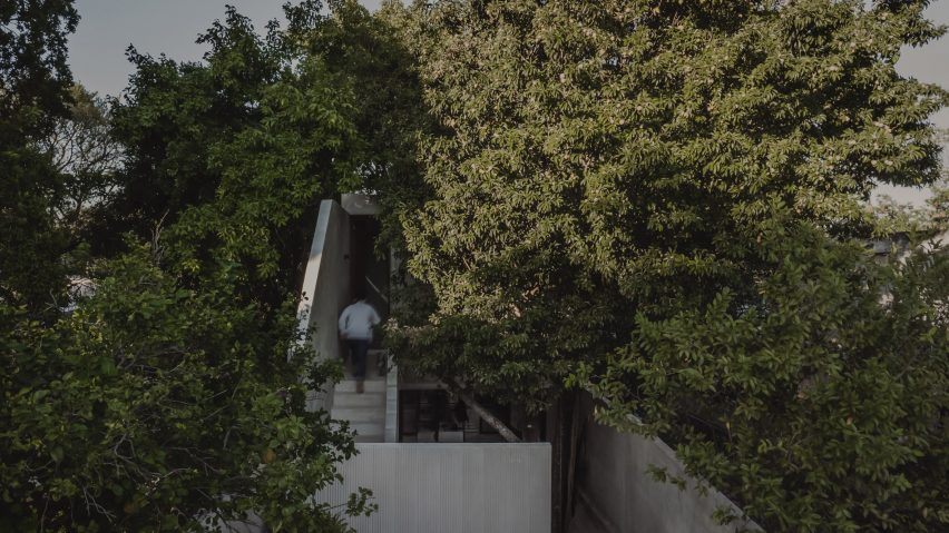 An outdoor staircase leads to a bedroom in the rear dwelling