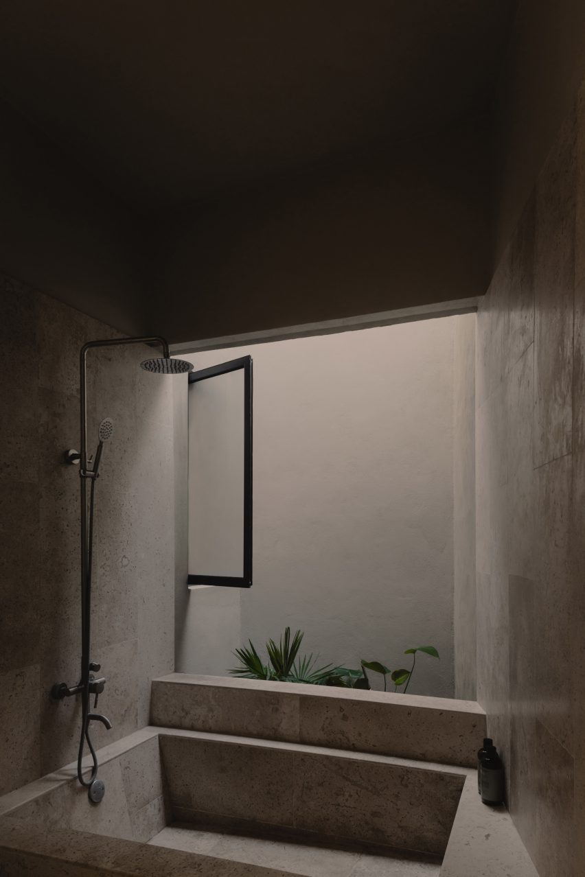 Concrete bathroom with sunken bathtub