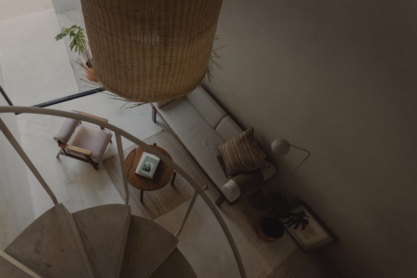 Interior of the smaller El Tiron dwelling with open-plan living and spiral staircase leading to a mezzannine level