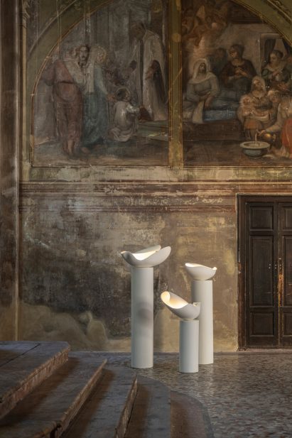 White lamps with fresco in the background