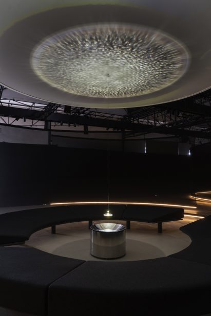 Thetre-like room with circular bench in Google installation at Milan Design Week