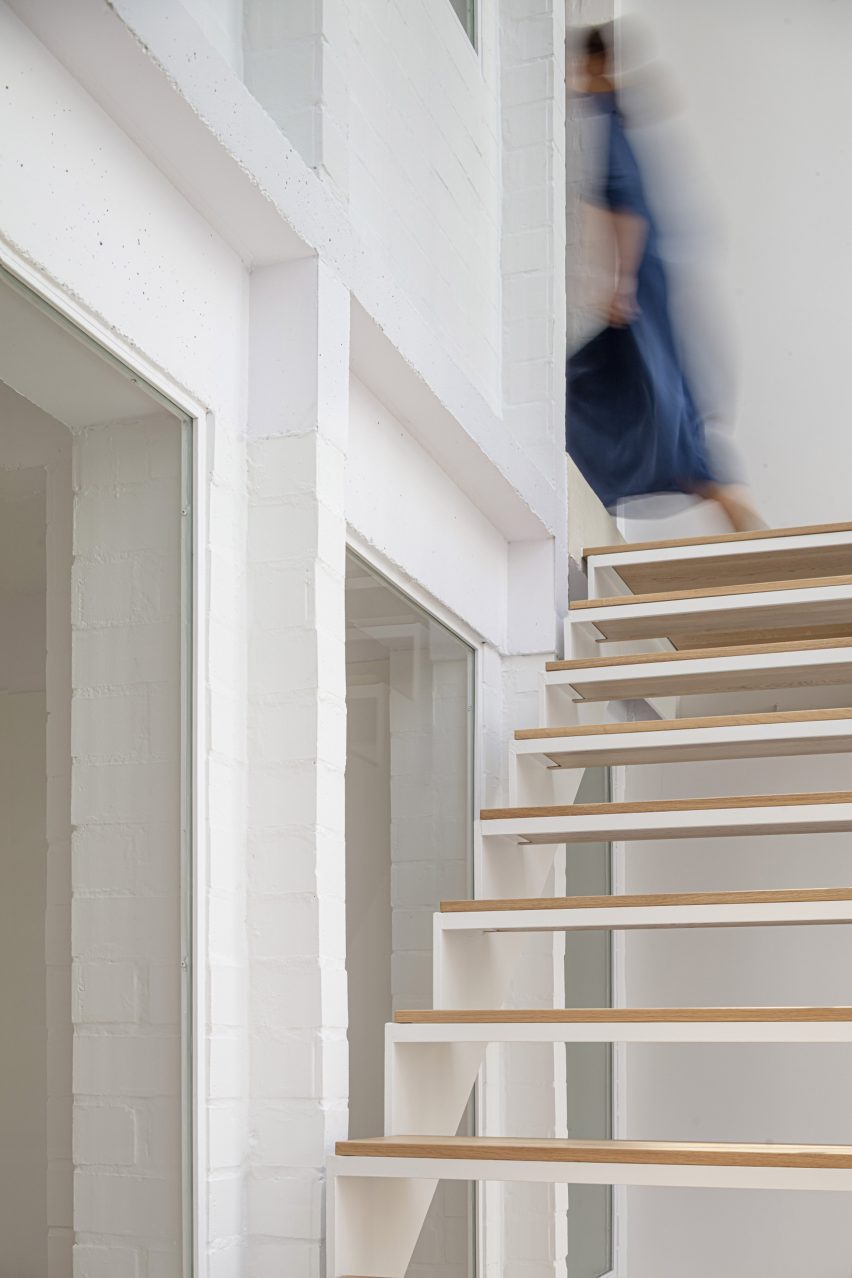 White interior with a a staircase with wood treads and gaps between them