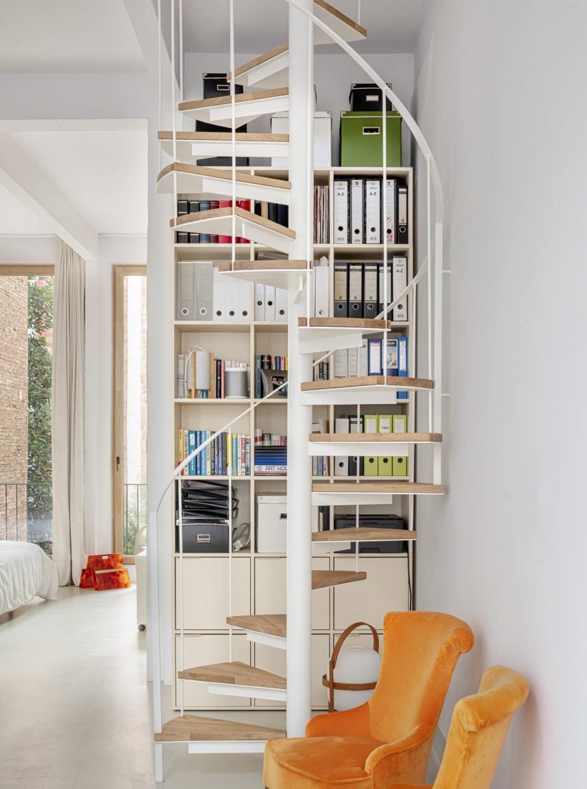 White interior with a spiral staircase with wooden treads