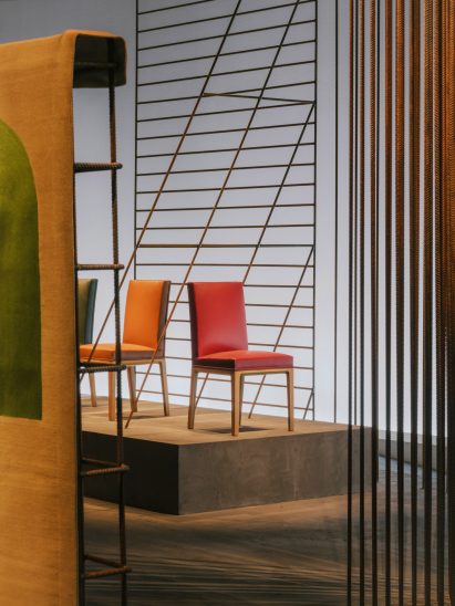 Colourful chairs on concrete plinths