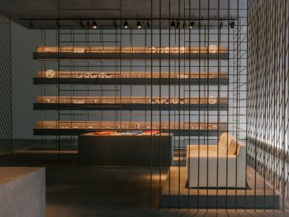 Iron rods and concrete plinths displaying homeware by Hermès