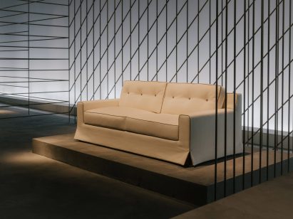 White wool and cotton sofa on concrete plinth