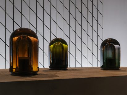 Lantern-style coloured lamps on concrete plinths by Hermès