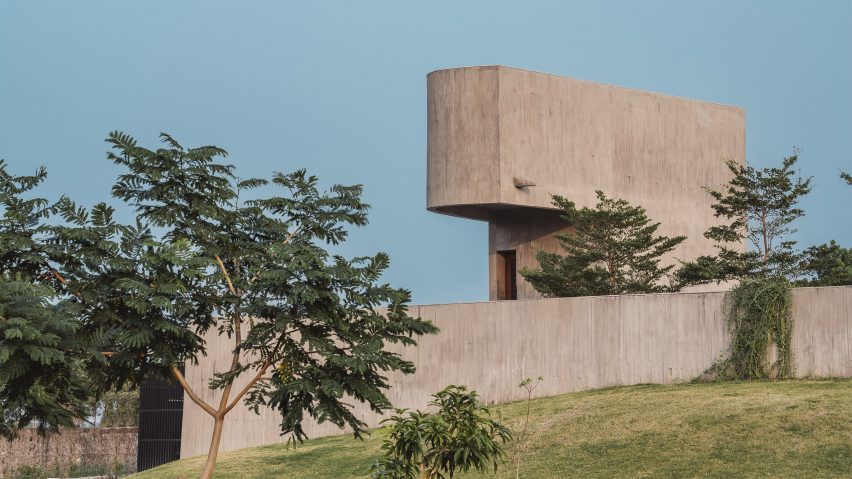 Grass hill with a concrete wall and curved concrete structure