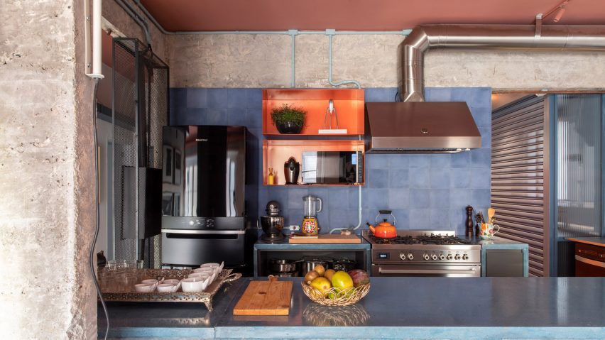 Kitchen at the RF Apartment with concrete walls and peach ceiling