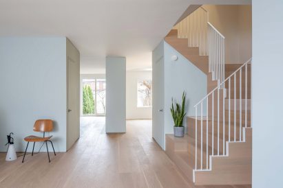 Ground floor divided by pale blue storage volumes