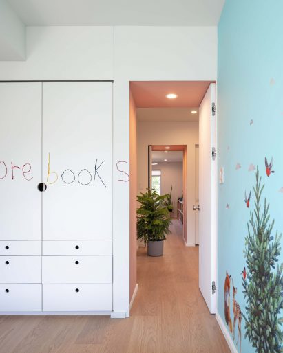 Kid's room with patterned wallpaper and writing on a closet door