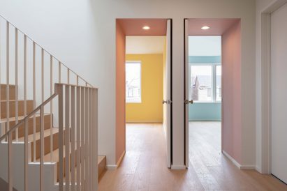 Bedrooms viewed through deep portal doorways coloured dusty pink
