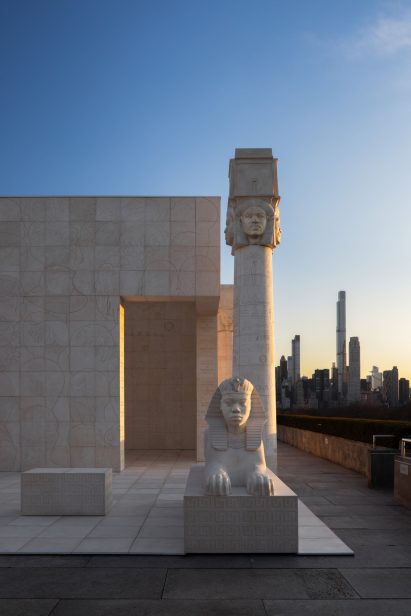 Sphinx with pillar and Billionaires Row in the background at sunset