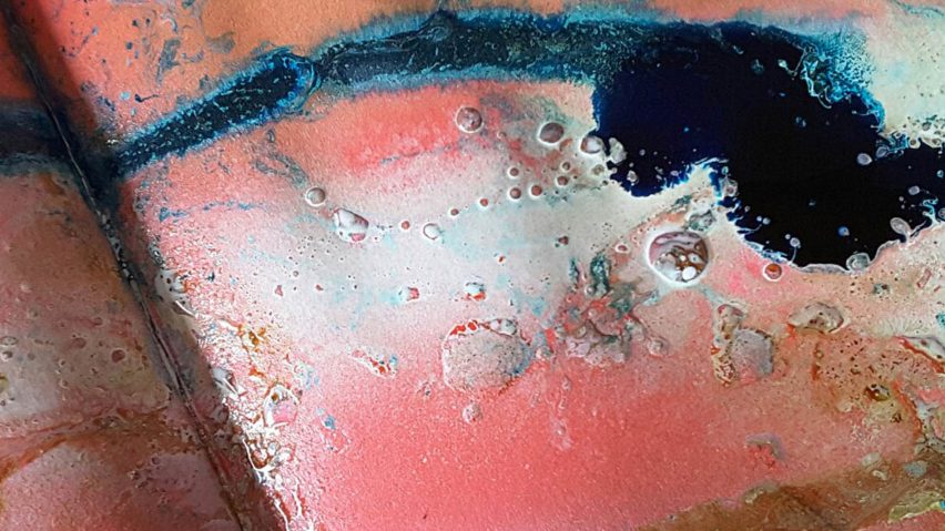 a surface with rusts in pink, white, blue and black