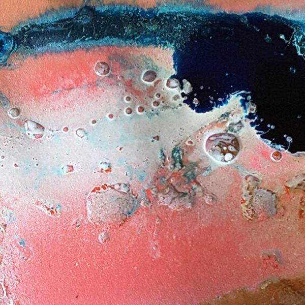 a surface with rusts in pink, white, blue and black
