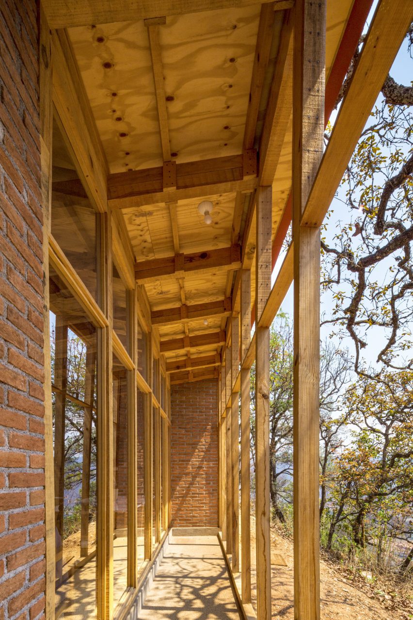 Brick home with a wooden porch on a sandy hill