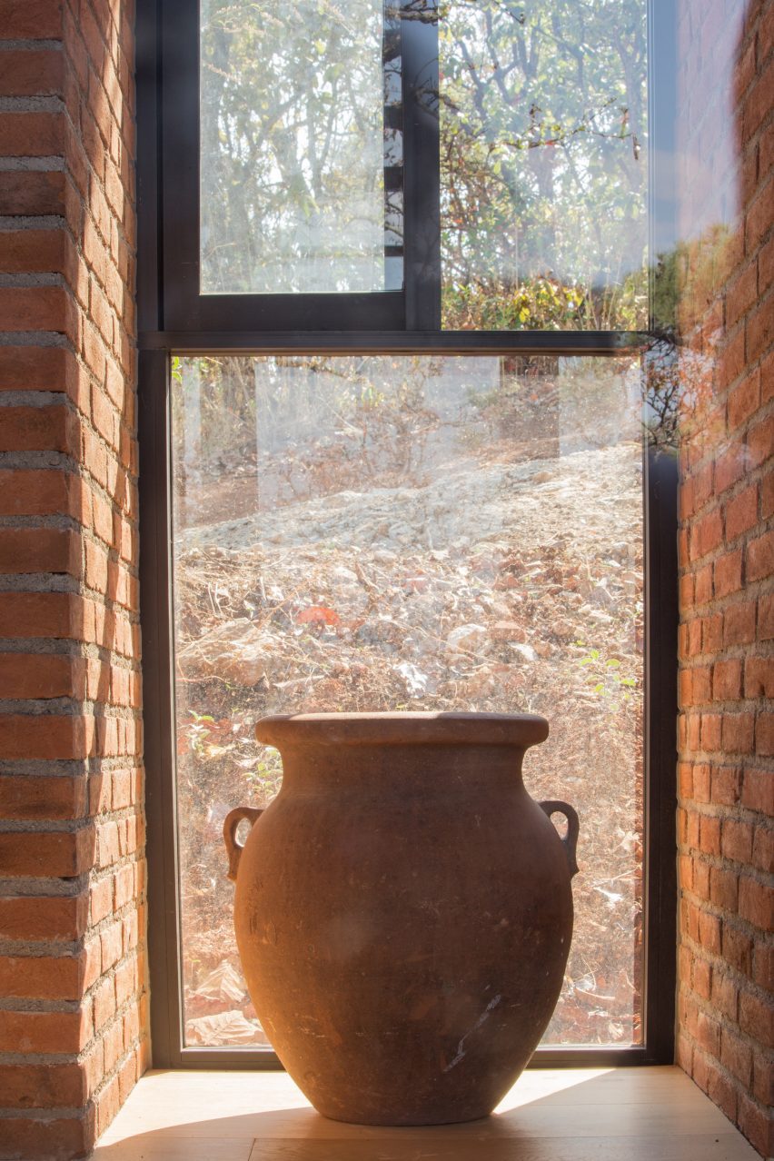 Cermaic pot on a window sill with brick walls