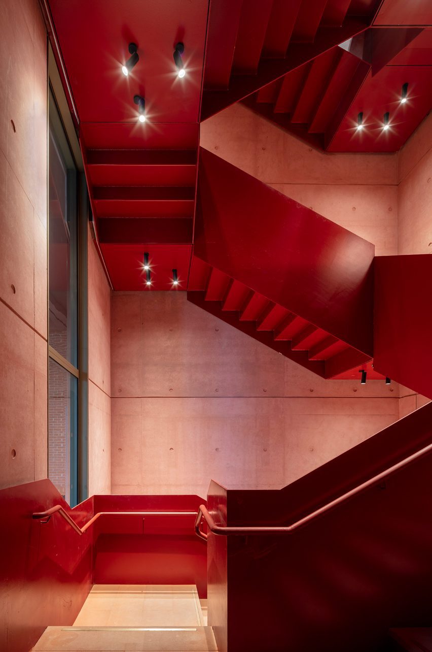 Red interior staircase at the International Rugby Experience building by Niall Nclaughlin Architects