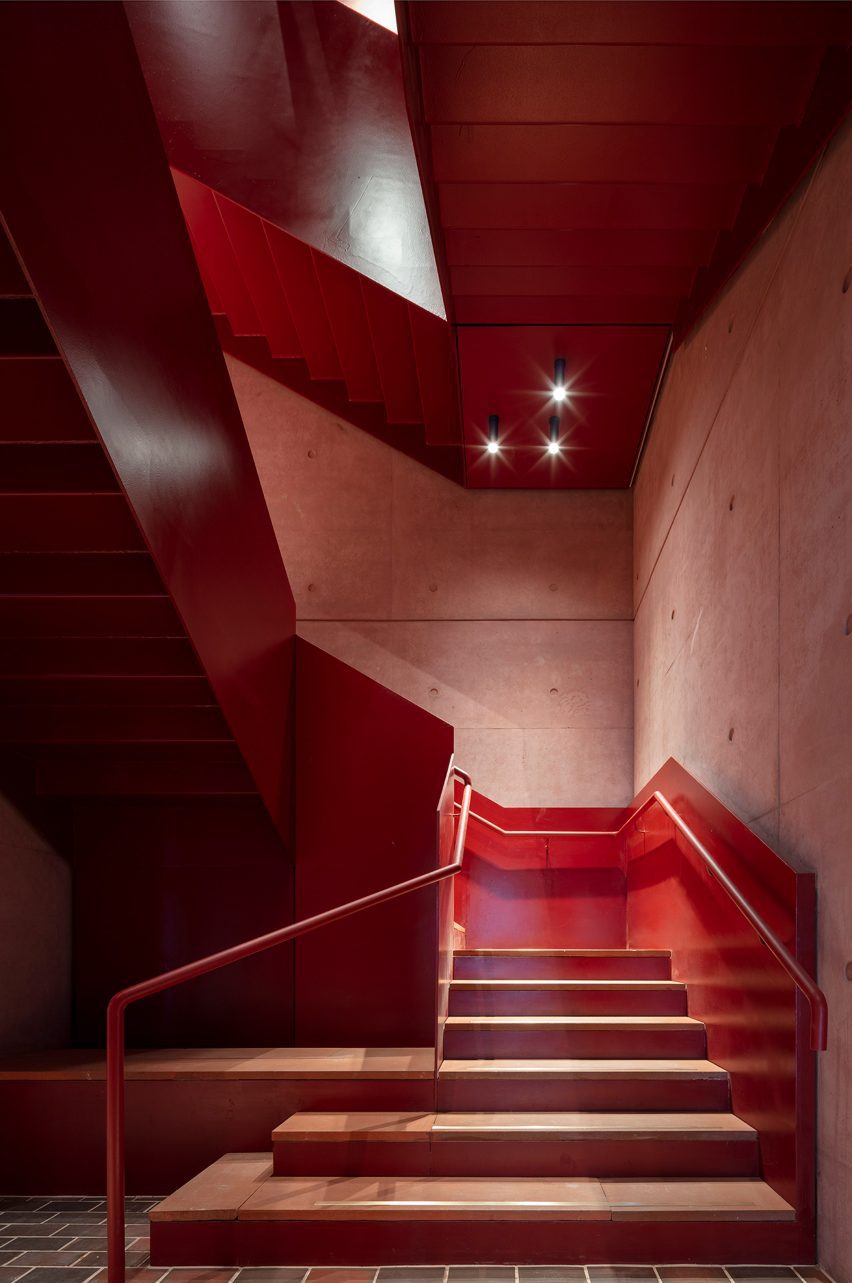 Red interior staircase at the International Rugby Experience building by Niall Nclaughlin Architects