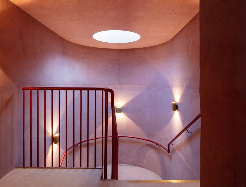 Red interior staircase at the International Rugby Experience building by Niall Nclaughlin Architects
