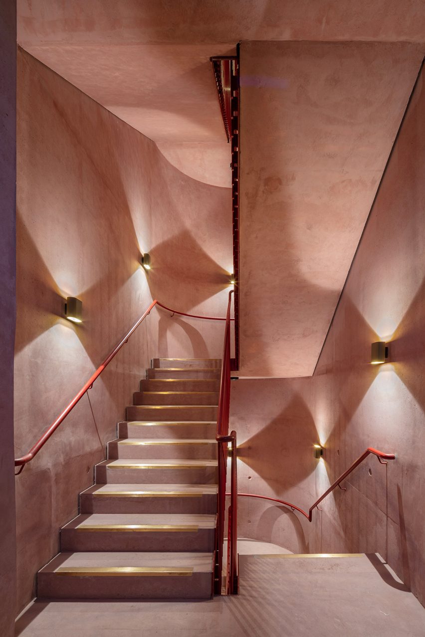 Red interior staircase at the International Rugby Experience building by Niall Nclaughlin Architects