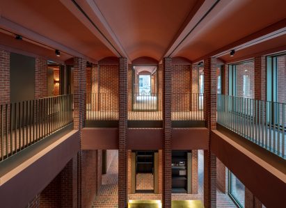 Red-brick interior of the International Rugby Experience building by Niall McLaughlin Architects with arched ceilings at the International Rugby Experience building by Niall McLaughlin Architects