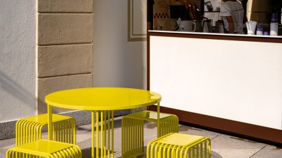Yellow dining set outside coffee kiosk