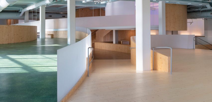 Interior of the Bronx Children's Museum with wood flooring and curved wooden elevated walkways